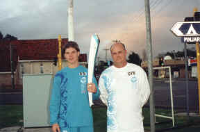 Matt Adamczyk (blue) holds the torch in Pinjarra, WA (Click to enlarge)